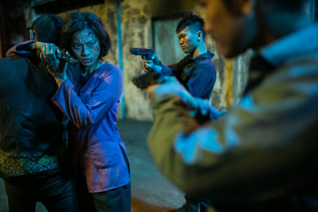 Veronica Ngo pointing gun to hunchmen in Vietnam film - FURIE
