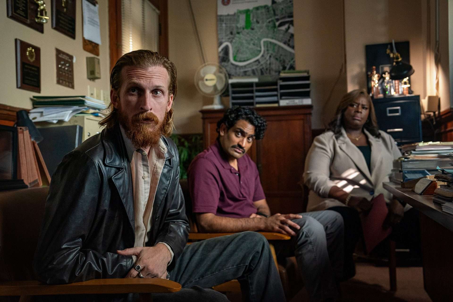 Hit Man Ending. (L-R) Austin Amelio as Jasper, Sanjay Rao as Phil and Retta as Claudette in Hit Man. Cr. Brian Roedel/Netflix © 2024