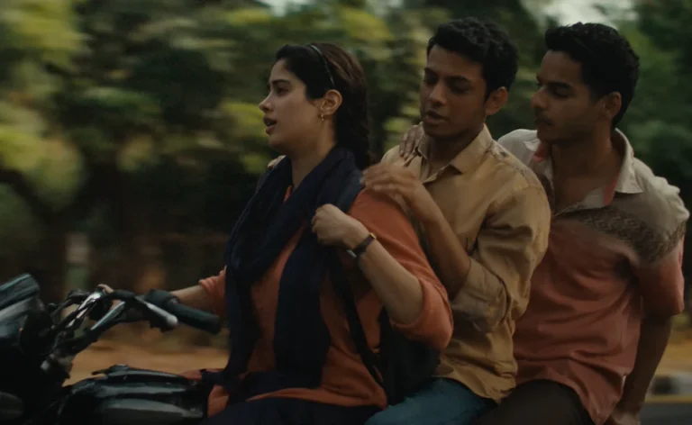 Between Surnames and Silences: The Unflinching World of Neeraj Ghaywan’s ‘Homebound’ (2025) Chandan and Shoaib, the protagonists of Ghaywan’s world, stand at opposite poles-- the former, a Dalit man from a scheduled caste; the latter, an orthodox Muslim. Though they share little in common, they are bound together, ever-so-strongly, by an unrelenting desire to break free from the shackles imposed by society. Yet as the film unfolds, we realise that more than society, it is themselves they must escape from.  In his relentless attempt at spotlighting pressing socio-economic realities, Ghaywan lays bare a blistering truth: a significant portion of one’s identity is predetermined at birth, with no room for choice. The rest of life becomes a sentence, a punishment-- a burden of carrying that truth until the very last day. What follows is a cruel decision: to fight for balance, or to conceal and retreat in order to survive. Both paths are unjust, yet both remain undeniable verities.  What “Homebound” does effortlessly is interrogate identity, religion, and caste erasure through a deeply personal, juxtaposed lens. Its characters do not merely wear these labels; they live and breathe them each day. For those born with higher immunities, such hierarchies might appear to matter only when filling out forms or applying for jobs. Yet the film insists otherwise-- it roots discrimination in the most mundane acts: filling a water bottle, sharing a meal. In these banal moments, when surnames don’t align with the standards, one is made distinctly aware of exclusion.  Several poignant moments highlight this duality-- the two-edged sword of identity. To reveal or not to reveal. That is the question. The stark dichotomy emerges in the mindsets of Chandan and Shoaib. Chandan, quiet and withdrawn, is the boy who never raised his hand in class, who always chose silence. On official forms, he ticked the “General Quota” box despite belonging to a Scheduled Caste-- shielding himself from torture and name-calling at his university or police job. So fearful of revealing his surname, he often erased the question altogether, retreating into half-truths.  The tremor in his voice-- brought to life brilliantly by Vishal Jethwa-- betrayed his terror at disclosing who he truly was. To survive, he would dismiss caste inquiries by calling himself a Brahmin or restricting himself to just his first name. His lover, Sudha, captures the futility of such concealment when she tells him: “Even if we end up with the same job, the same uniform, solving the same problems, we’ll still eat on the floor while they sit on high-chairs. That is why I carry my own chair wherever I go.”  Do Check Out: Homebound (2025) ‘Cannes’ Movie Review: Neeraj Ghaywan’s Sophomore Feature Continues His Caste Examination With A Classically Dramatic Touch Shoaib, on the other hand, is Chandan’s opposite. Proud, outspoken, and uncompromising, he wears his religion and identity on his sleeve. He refuses to conceal his Muslim background, never bowing under pressure. But his courage comes with a cost. He is met with intensified discrimination and hostility. His senior refuses to let him touch his water bottle, insisting he will fill it himself. At work, he is asked to provide unnecessary documents, subjected to repeated background checks designed to exhaust him. At a corporate party, he is mocked as a Pakistani sympathiser, handed Lahori Korma to taste because, of course, he would “know how it should be cooked.” What begins as playful banter descends into humiliation so deep that Shoaib quits his respectable job and accepts a demotion he never wanted.  The two men embody opposing strategies for survival: Chandan hides and climbs the ladder, Shoaib reveals and slips down it. Yet Ghaywan’s message is stark: neither path leads to liberation. Our society has made existence itself a curse, forcing individuals into impossible binaries: reveal or conceal, fight or retreat. Whichever choice you make, the cost is unbearable. We impose so many labels, standards, and hierarchies that embracing difference feels like an affliction. The film suggests we are inching toward a dystopia of uniformity, where everyone becomes a puppet, a cog, a robot.  This despair resonates most vividly in the film’s pandemic sequences. Survival is not simply about resilience… It’s about origins, surnames, and connections. Aid is rationed according to where you come from and who you are. While the wealthy remain shielded in their mansions or travel in SUVs, the poor trudge on foot from village to village, changing transport endlessly, only to suffer most despite having laboured hardest. Their surnames lack weight; their identities offer no shield. And yet, even in this climate of abandonment, they find refuge in each other. What society denies them in dignity, they reclaim in companionship.  At every turn, life hurls another curveball: brief moments of fortune followed swiftly by storms. The narrative’s peaks and troughs leave the audience breathless, aching with the heaviness of not belonging. There is not a single setting in which the weight of their identities did not bear down on them, except when they are in each other’s presence. Only there is a certain sense of unconditionality, where differences dissolve and only solidarity remains.  “Homebound” ultimately uncovers two profound truths. The first is that living in a society that prides itself on being liberal, diverse, and democratic is an unrelenting battle, because beneath the rhetoric, it remains chained to hierarchies of religion, caste, and identity. The film reveals how difficult it is to simply exist when your very name, your faith, or the community you belong to becomes a marker that others use to discriminate against you. There is no neutral ground, no win-win situation in a world where the baggage of identity follows you everywhere.  And yet, the film also insists on something softer, something hopeful. Even when society erases you, strips you of the weight of your surname or background, some bonds cannot be reduced to labels. There is a space where friendship, loyalty, and chosen family create a home untouched by prejudice. That’s where “Homebound” lingers… in the tension between erasure and belonging, between bitterness and tenderness. It shuns the cruelty of systems that divide, while at the same time reminding us of the beauty of bonds that heal, protect, and endure. Also Read: A Humanistic Mirror to India’s Fault Lines: Neeraj Ghaywan’s ‘Homebound’ Homebound (2025) Movie Links: IMDb, Rotten Tomatoes, Wikipedia, Letterboxd