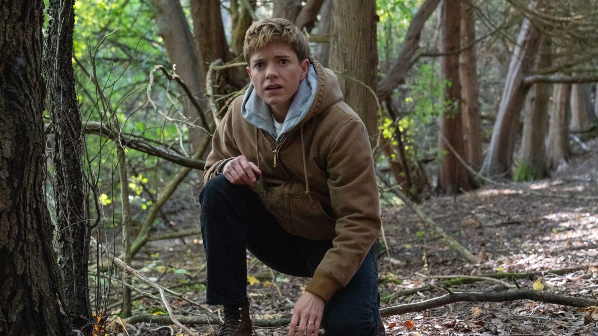 Mae Martin as a character exploring the forest in Netflix’s series Wayward.