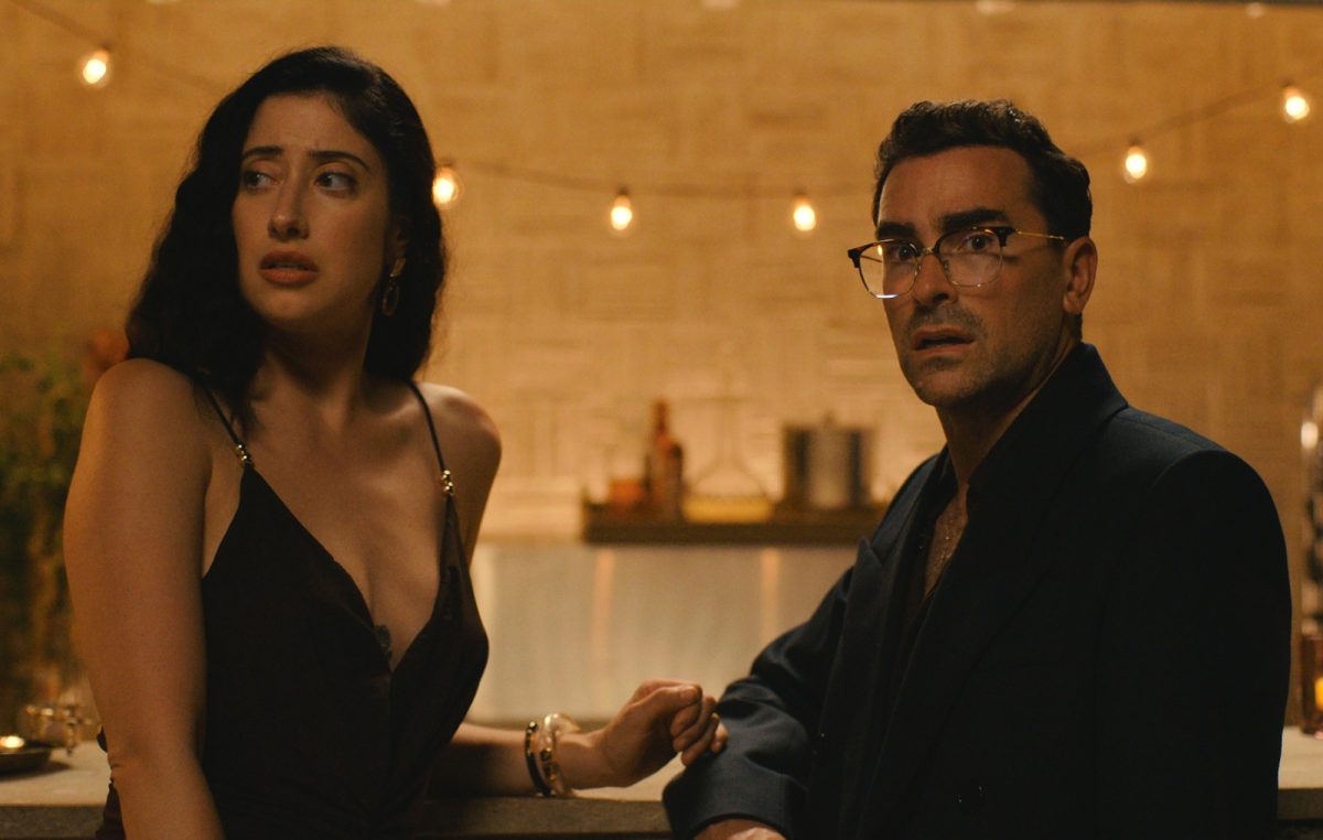Dan Levy and Taylor Ortega looking startled in a scene from the Netflix series Big Mistakes.